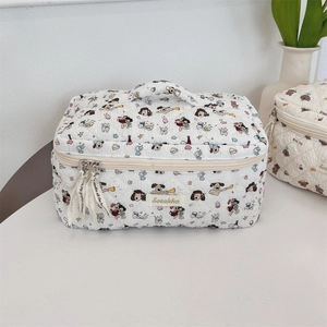 Detail of quilted cosmetic bags with cute cartoon prints and sturdy top handles
