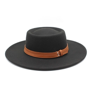 Detail of the black flat-top felt hat showing the brown leather strap and metal studs