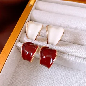 C-shaped wide hoop earrings in cream white and burgundy red with gold plating