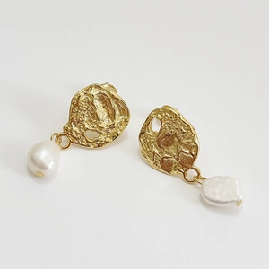 Bohemian baroque pearl earrings with gold pleated texture on a white background
