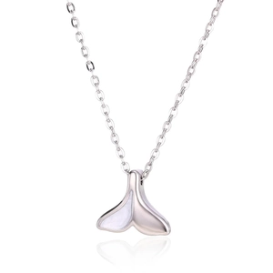 Macro view of silver fish tail pendant with white shell inlay on a delicate chain