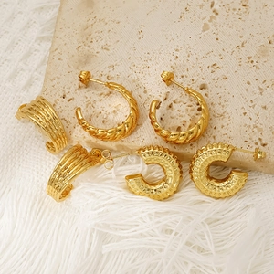 Three pairs of vintage gold stainless steel hoop earrings in C-shape designs