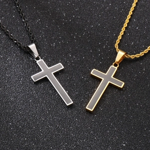 Detail of silver and gold cross pendants with black enamel inlay on thick rope chains