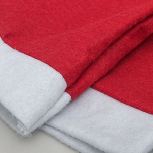 Close-up of red non-woven fabric and white fuzzy trim on a Christmas chair cover