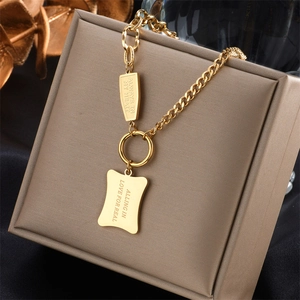 Detail of gold titanium steel necklace with Always in My Heart and Falling in Love engraving