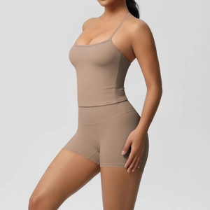 Detail of coffee brown two-piece yoga set with slim fit strappy tank and high waist shorts