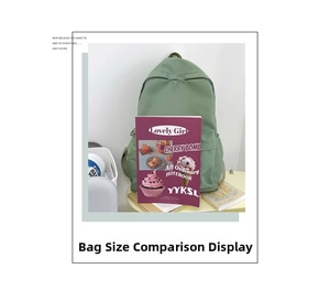 Detailed view of the light green casual backpack showing capacity next to a notebook