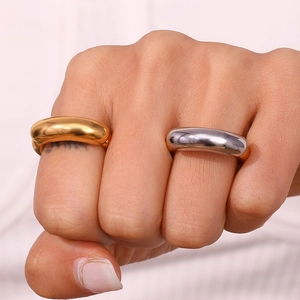Minimalist gold and silver polished chunky stainless steel smile rings on fingers