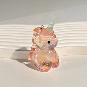 Detailed close-up of iridescent acrylic unicorn charm with colorful gradient finish