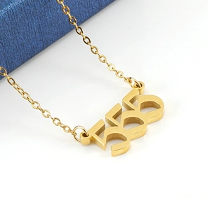 Macro shot of gold 555 lucky number pendant with elegant link chain on blue stand