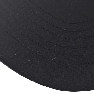 Detailed macro view of parallel stitching and fabric texture on a black curved hat brim