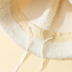 Detail view of the soft faux fur bucket hat featuring an adjustable inner drawstring