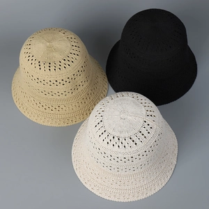 Close-up of three hollow knit bucket hats in black, beige, and khaki with breathable texture