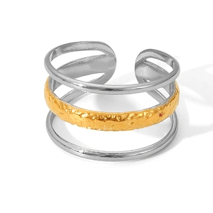 Detail of three-layer mixed metal ring with gold hammered texture and silver bands