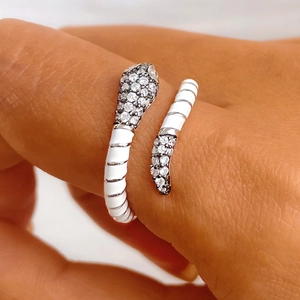 Detail of S925 silver snake ring with white enamel and shimmering cubic zirconia stones