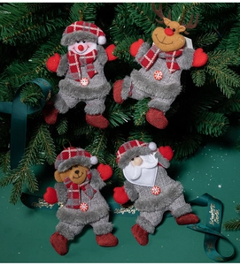 Detail of plush Christmas tree ornaments featuring Santa, snowman, reindeer, and bear