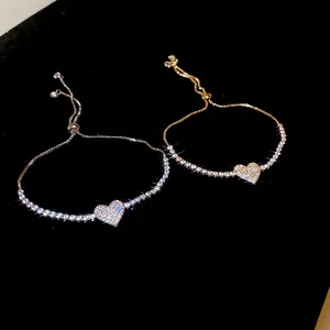 Elegant adjustable heart bracelet with sparkling cubic zirconia on a black background