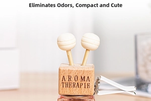 Detail view of square wooden aroma diffuser block with glass bottle and air vent clip