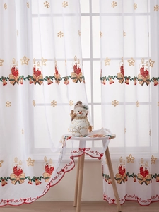 Detail of Christmas embroidered sheer curtain with red candles, bells and snowflake patterns