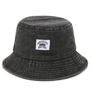 Retro washed black denim bucket hat with Brooklyn fabric patch and metal eyelets