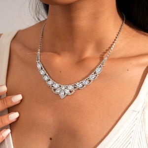 Close-up of elegant silver floral marquise necklace set with sparkling crystals on collarbone