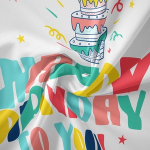Detail of bohemian Happy Birthday tapestry showing colorful cake print and soft fabric texture