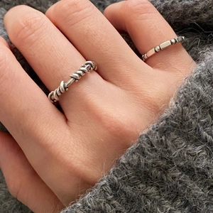 Detailed shot of retro 925 silver rings with twisted rope and geometric bead textures