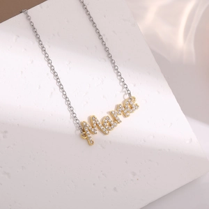 Detailed macro view of MAMA letter pendant with sparkling gems on a fine silver chain