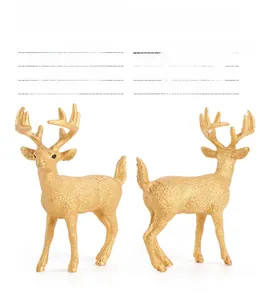 Detailed male white-tailed deer figurine in gold finish showing anatomical muscle textures