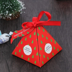 Creative pyramid-shaped red Christmas gift box with ribbon and festive gold lettering