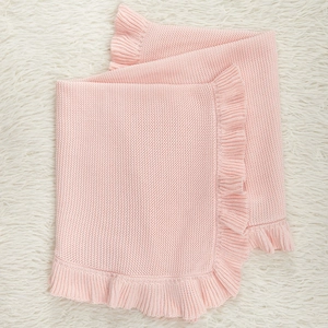 Pink knit baby blanket with ruffle trim detail, soft cotton infant stroller cover