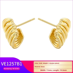 Macro detail of gold plated brass multi-layered claw stud earrings with wavy textures