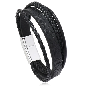 Detail of men's multi-layer black leather woven bracelet with silver magnetic alloy clasp