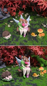 Detail of miniature garden fairy set with resin hedgehogs and snails on moss base