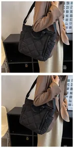 Detail view of the quilted black tote bag with adjustable strap and diamond stitching