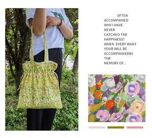 Detail of floral drawstring tote bag with drawstring closure and soft cotton fabric texture