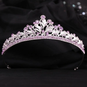 Elegant silver bridal crown with purple rhinestones on black background for wedding attire