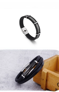 Detail of black silicone and woven leather bracelets with stainless steel magnetic clasps