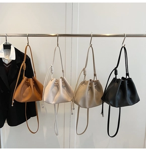 Detailed display of pleated cloud bucket bags in brown, beige, apricot and black finishes