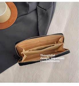 Interior view of black long wallet featuring multiple card slots and gold zipper pocket