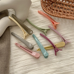 Morandi colors duckbill hair clips set on white fabric with minimalist decor