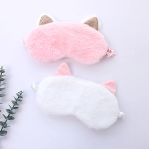Detail of soft plush cat ear sleep masks in pink and white with satin lining