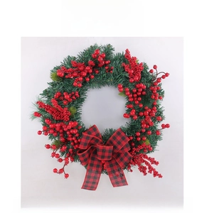 Detailed view of Christmas wreath featuring red berries and a buffalo plaid bow