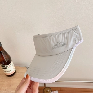Detail of grey running visor with mountain embroidery and durable stitched brim