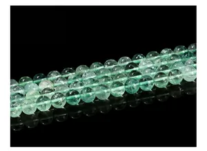 Macro shot of natural green fluorite beads showing internal ice cracks and texture