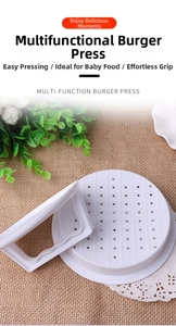 Macro view of white burger press mold with drainage holes on a rustic kitchen background