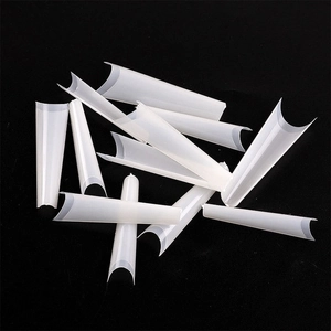 Macro view of long coffin-shaped semi-transparent white false nails with smooth edges
