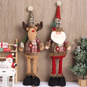 Standing Christmas plush dolls with Santa and Reindeer on rustic wood background