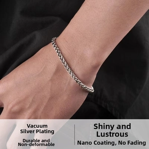 Macro detail of silver wheat chain bracelet showing vacuum plating and nano coating finish