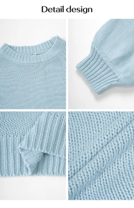 Close-up of the light blue cable knit sweater showing ribbed crewneck and soft fabric texture